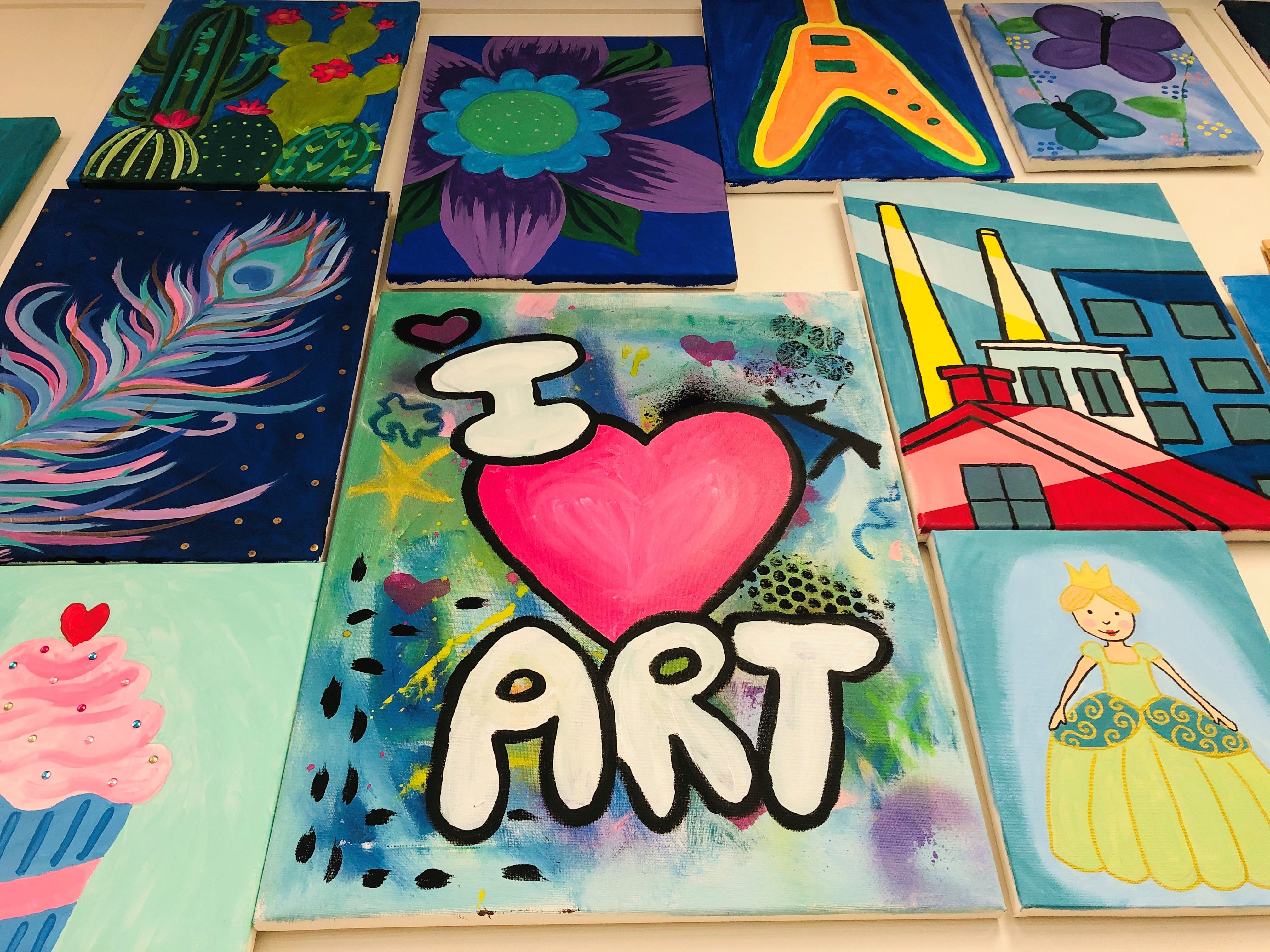 image of colorful abstract painted canvases featuring one with I heart art in the middle of the image