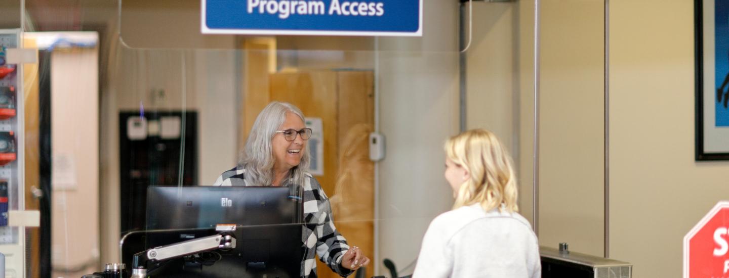 Receptionist serving a patron