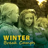 A group of girls smiling at winter break camp