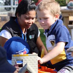 childcare leader with child playing