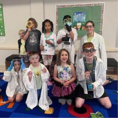 Summer camp kids wearing scientist costumes