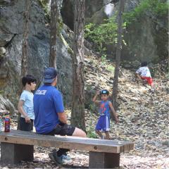Image of after school care leader with kids in nature
